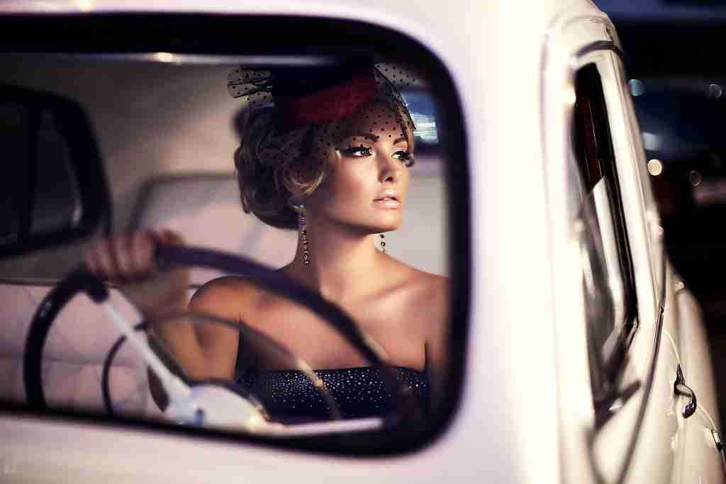 beautiful sexy fashion blond girl model with bright makeup curly hairstyle retro style sitting old car
